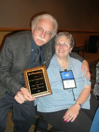 Mensa Member Betsy Mark congratulates Harry Ringermacher